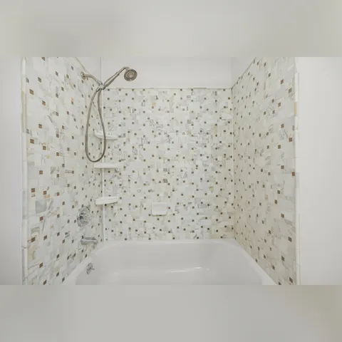 a bathroom with a bathtub and shower