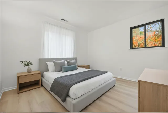 a bedroom with a bed and a window