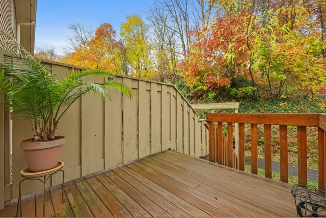 a view of a balcony with wooden floor and chair