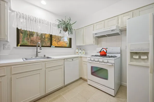 a utility room with sink dryer and washer
