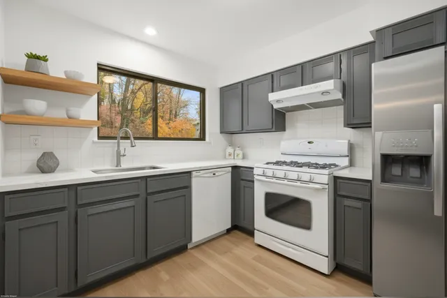 a kitchen with a stove oven and sink