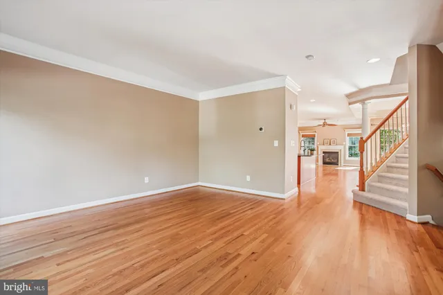 a kitchen with stainless steel appliances granite countertop a refrigerator a stove and a wooden floors