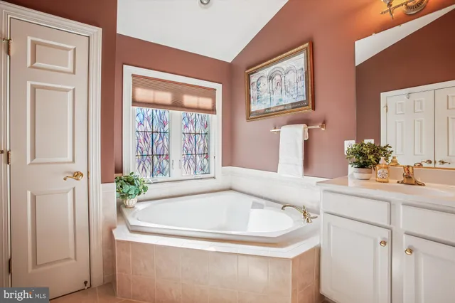 an empty room with windows and fireplace