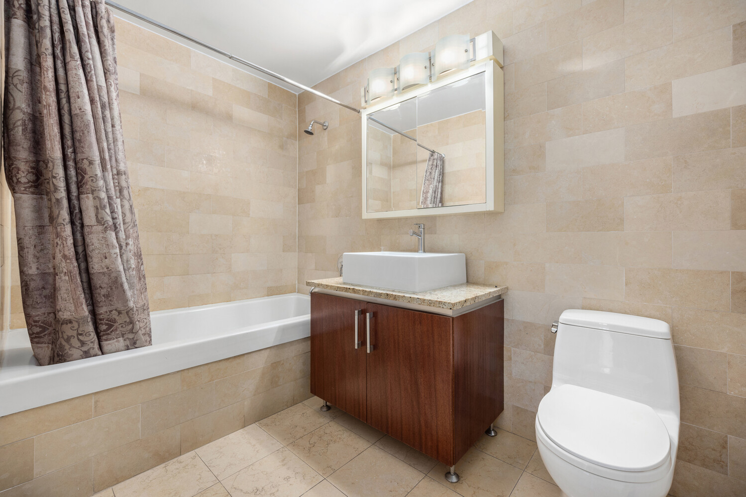 41-26 27th Street, Unit 3D Queens, NY 11101 - Photo 13 of 29 a bathroom with a sink a toilet and a bathtub