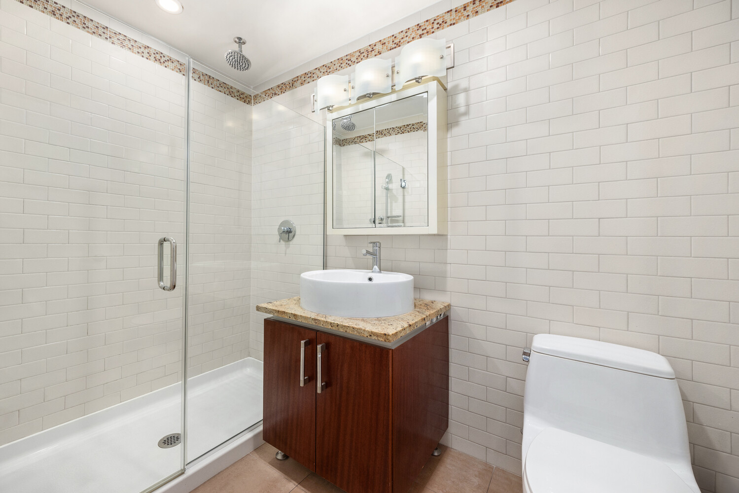 41-26 27th Street, Unit 3D Queens, NY 11101 - Photo 14 of 29 a bathroom with a sink a toilet and shower