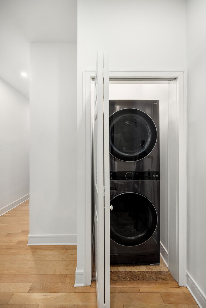 41-26 27th Street, Unit 3D Queens, NY 11101 - Photo 16 of 29 a view of a hallway with washer and dryer