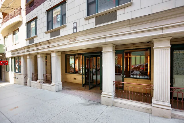 a living room with furniture and floor to ceiling window