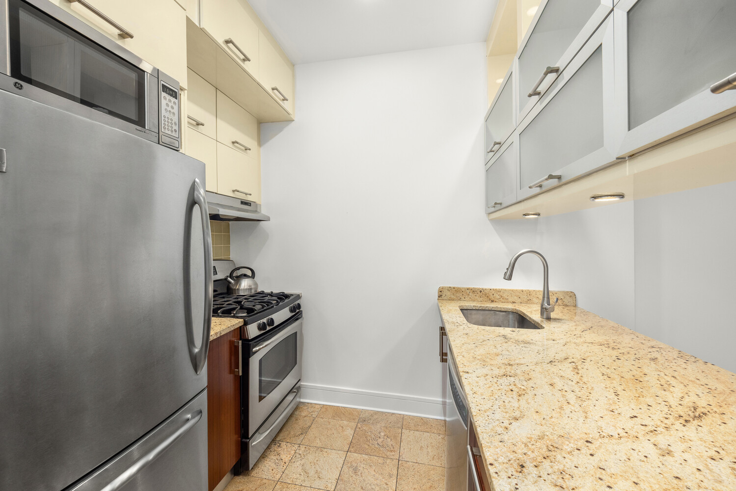 41-26 27th Street, Unit 3D Queens, NY 11101 - Photo 5 of 29 a kitchen with a sink a stove and cabinets