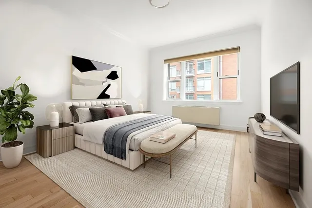 a bedroom with a bed couch and window