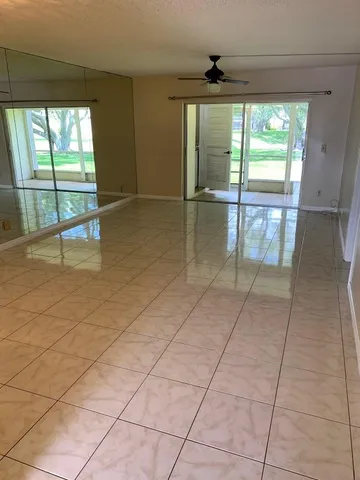 an empty room with floor to ceiling windows and an outdoor view