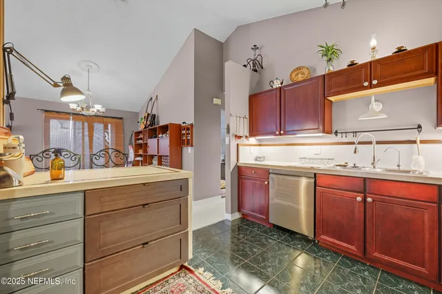 a kitchen with stainless steel appliances granite countertop a sink and cabinets