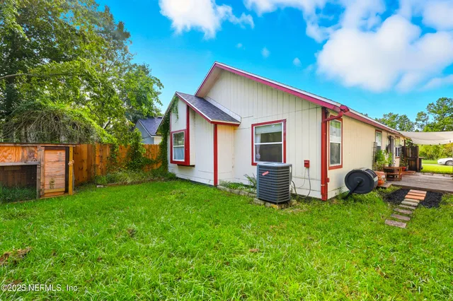 a backyard of a house with table and chairs