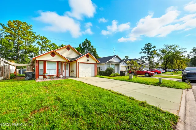 a front view of a house with a yard and garage