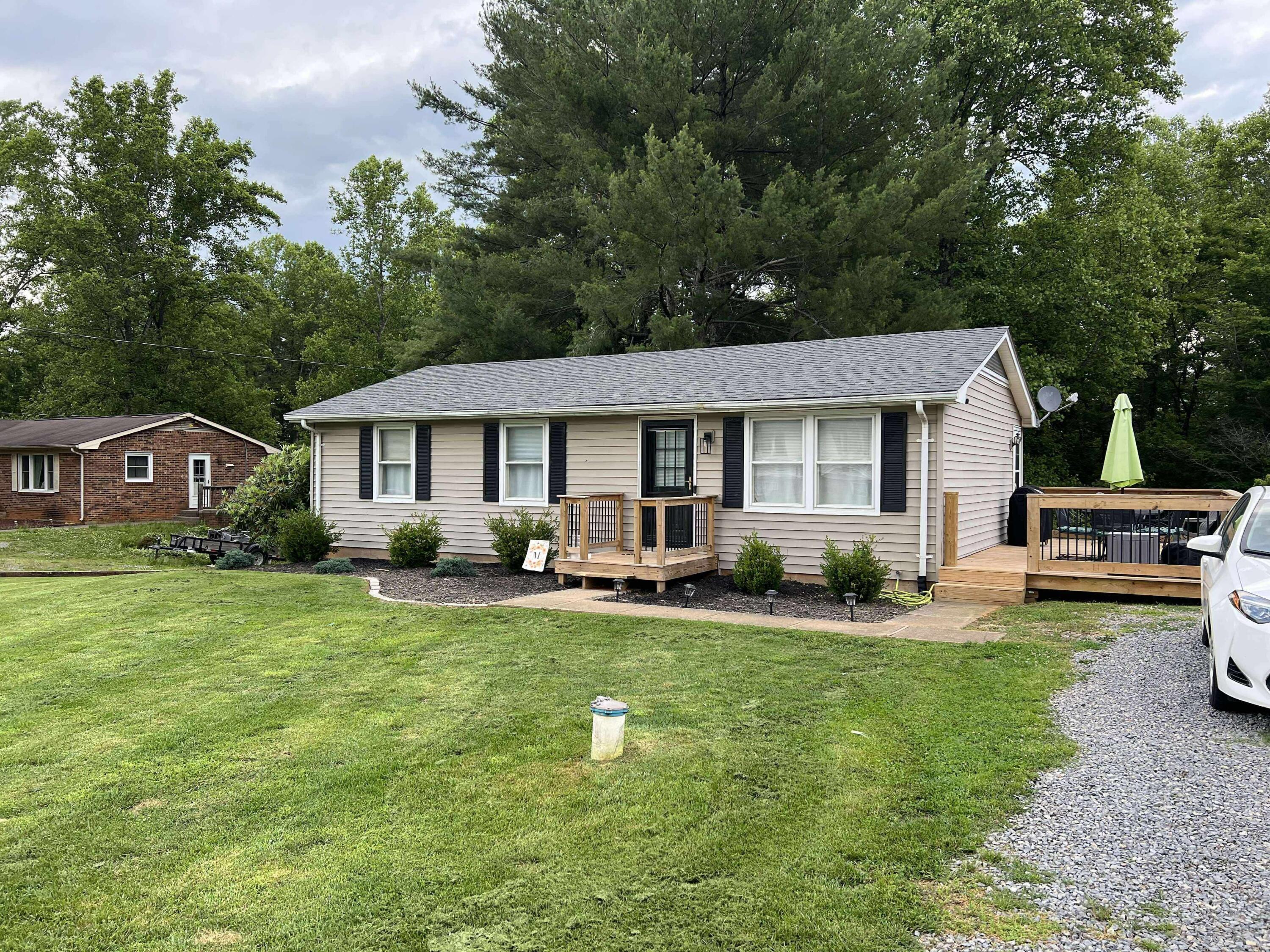 360 Rakes Road Rocky Mount, VA 24151 - Photo 2 of 32 a front view of a house with a yard porch and outdoor seating