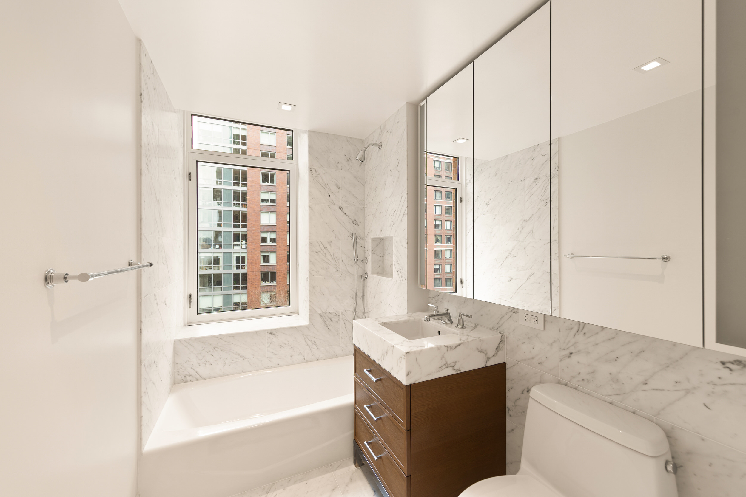 210 Warren Street, Unit 7A Manhattan, NY 10282 - Photo 7 of 9 a bathroom with a sink a toilet and shower