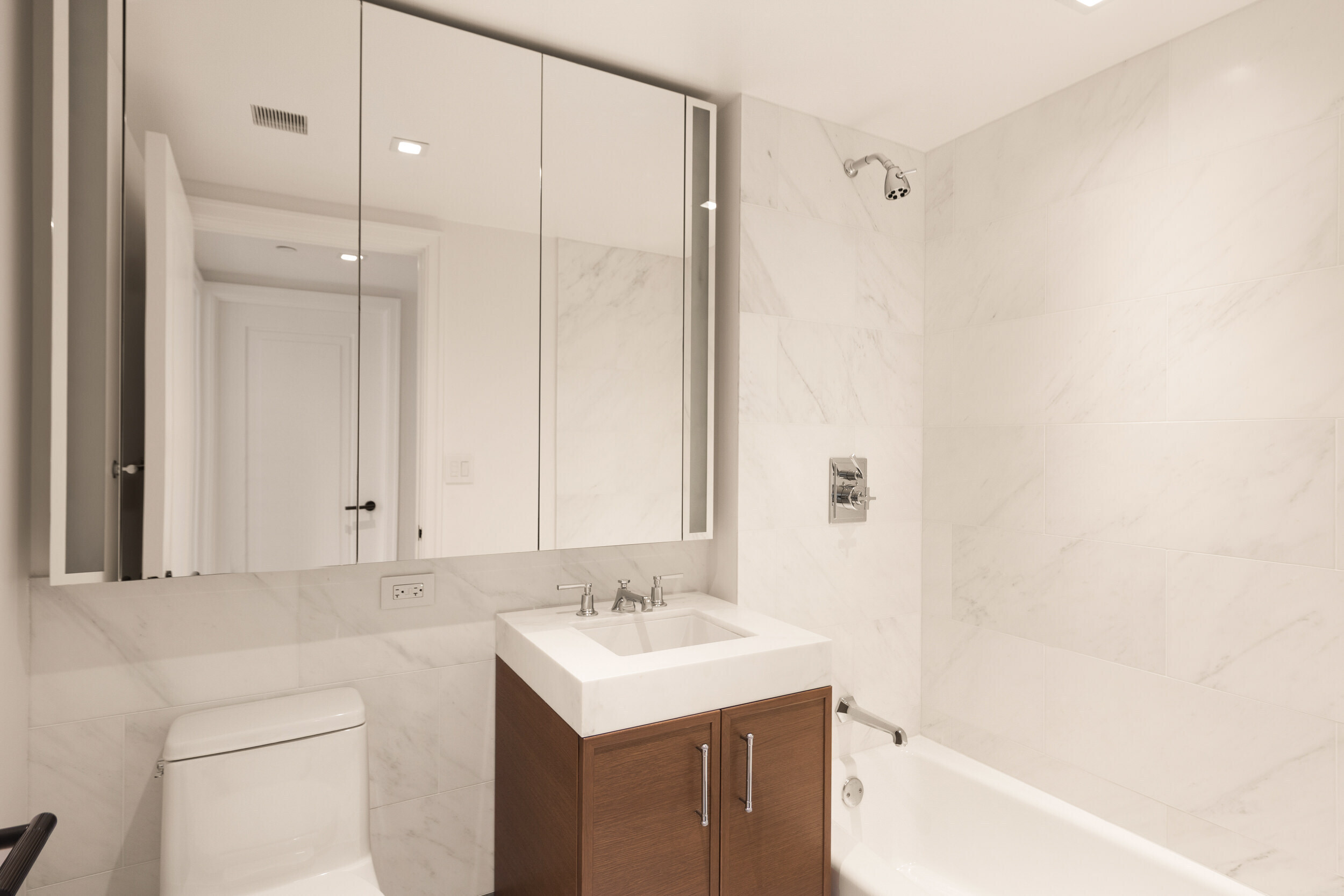 210 Warren Street, Unit 7A Manhattan, NY 10282 - Photo 9 of 9 a bathroom with a sink a toilet and shower