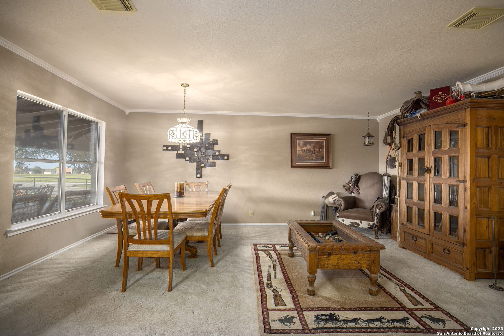 1940 Lower Seguin Road Marion, TX 78124 - Photo 14 of 49 a dining room with furniture a rug and a chandelier
