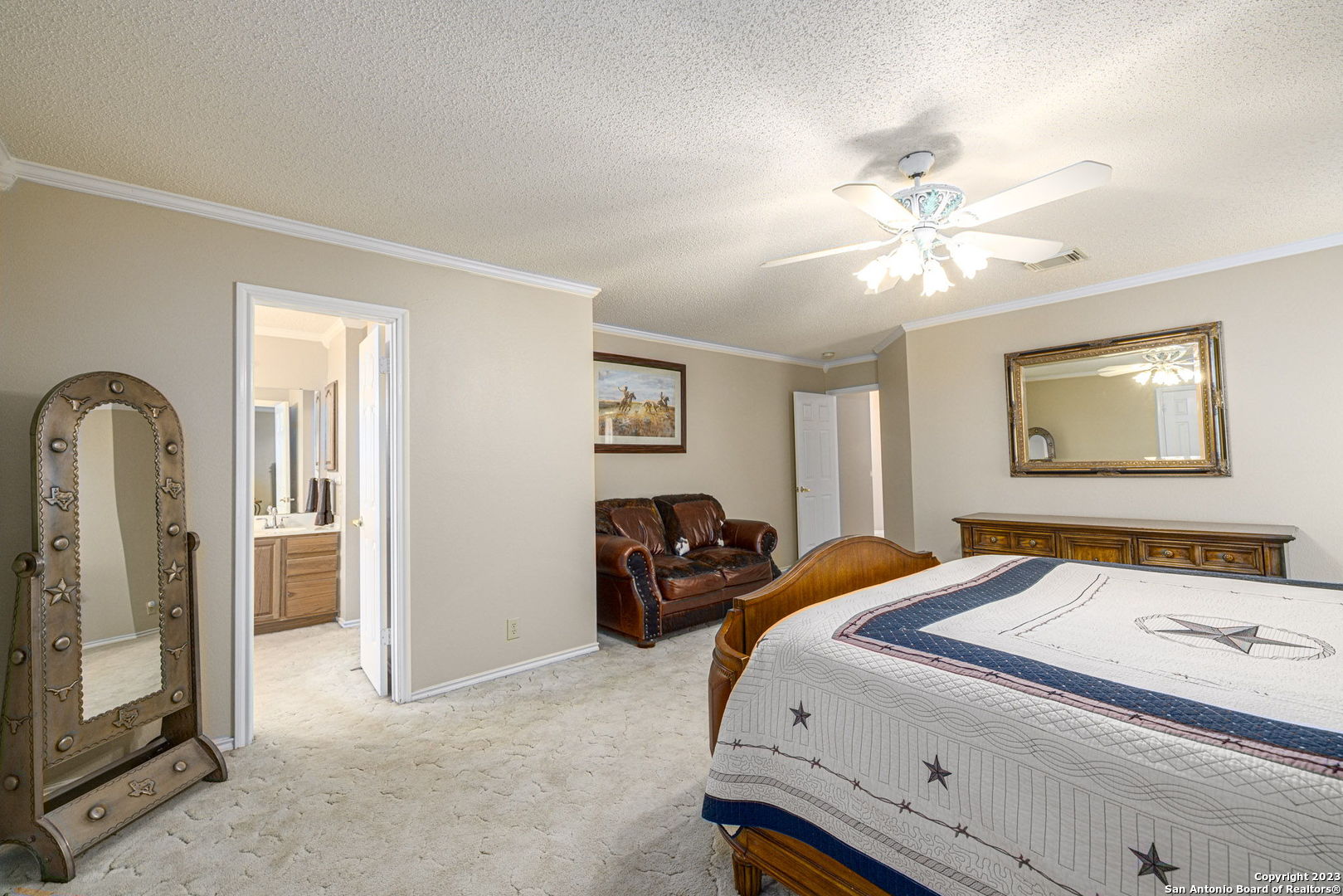 1940 Lower Seguin Road Marion, TX 78124 - Photo 20 of 49 a bedroom with a bed and a chandelier