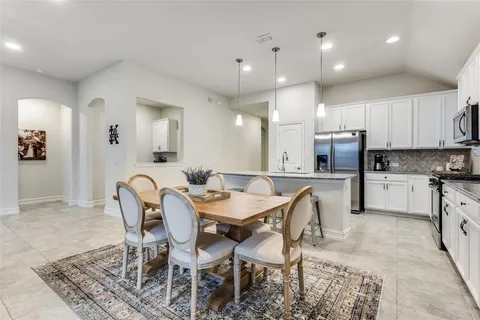a view of kitchen dining table and chairs