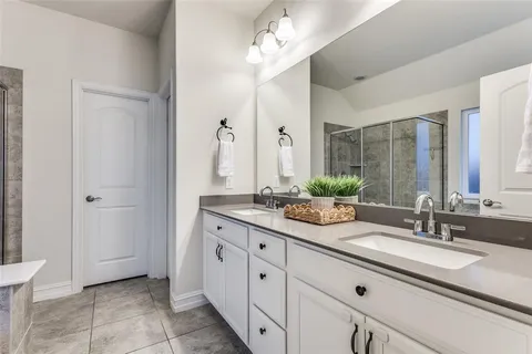a bathroom with a double vanity sink and a mirror