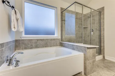 a bathroom with a bathtub and shower