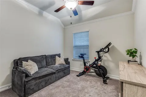 a view of a livingroom with furniture and a ceiling fan