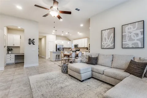 a living room with furniture and kitchen view