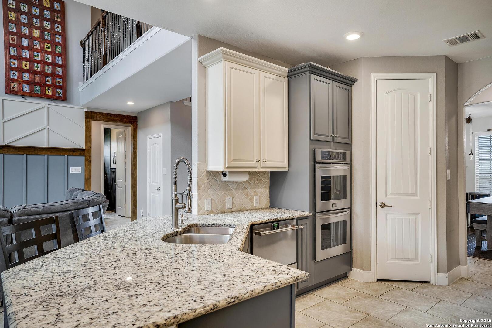 3754 Tumeric Cove Bulverde, TX 78163 - Photo 15 of 42 a kitchen with stainless steel appliances granite countertop a granite counter tops and a refrigerator