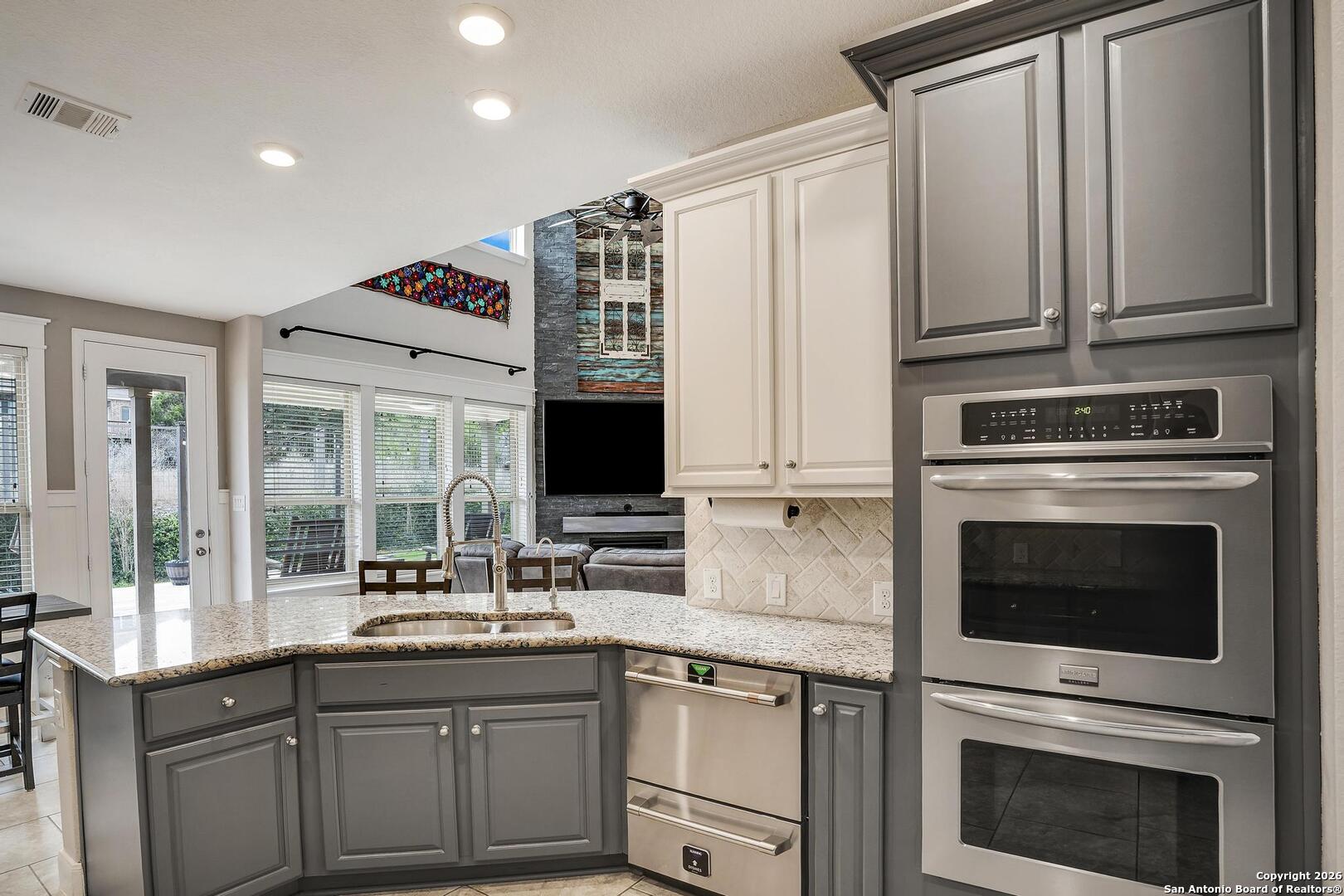 3754 Tumeric Cove Bulverde, TX 78163 - Photo 16 of 42 a kitchen with stainless steel appliances granite countertop a stove microwave and cabinets