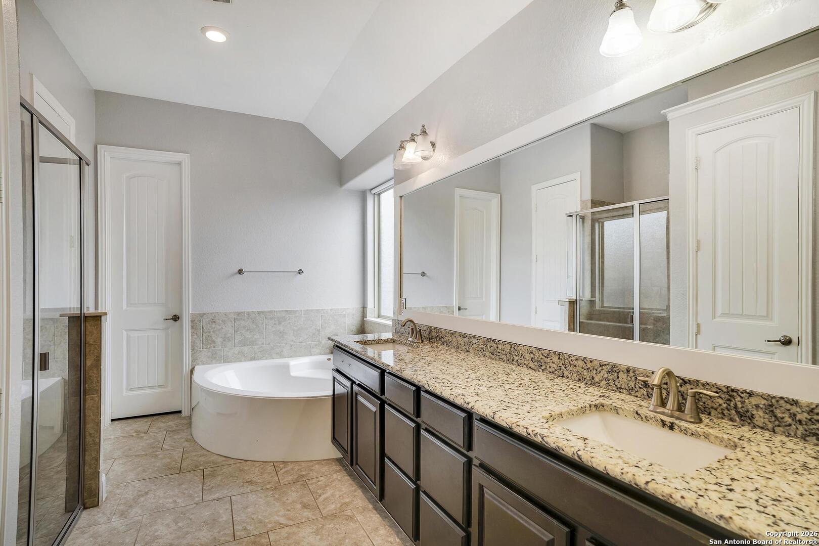 3754 Tumeric Cove Bulverde, TX 78163 - Photo 21 of 42 a bathroom with a granite countertop sink and a mirror