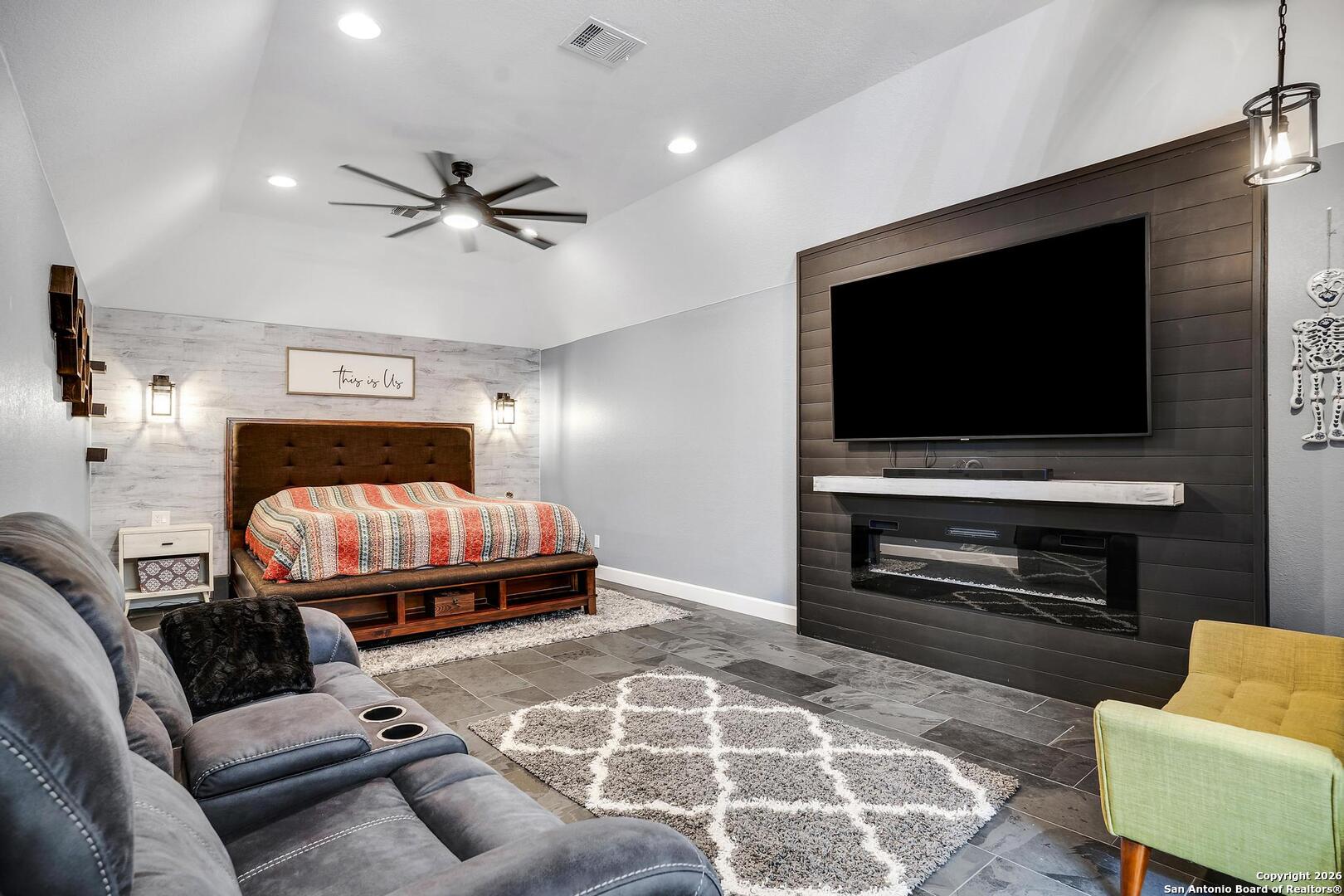 3754 Tumeric Cove Bulverde, TX 78163 - Photo 26 of 42 a living room with a flat screen tv and a fireplace