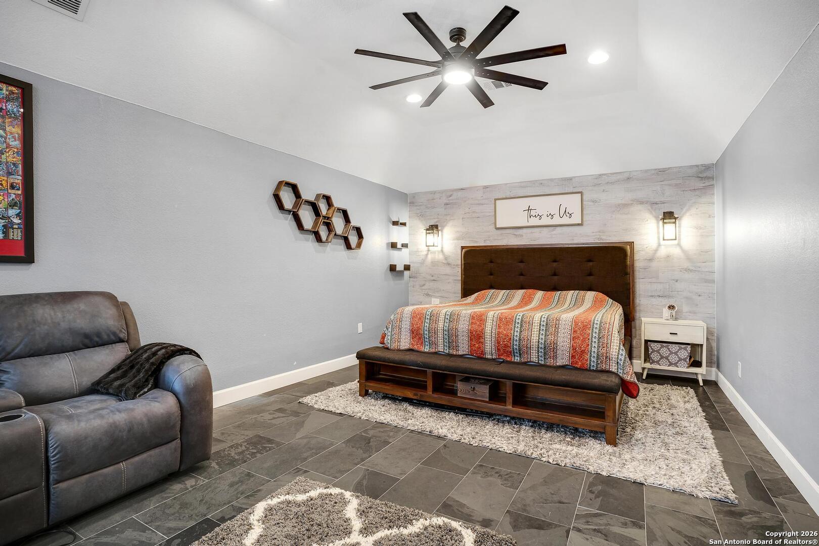 3754 Tumeric Cove Bulverde, TX 78163 - Photo 27 of 42 a bedroom with a bed and a couch