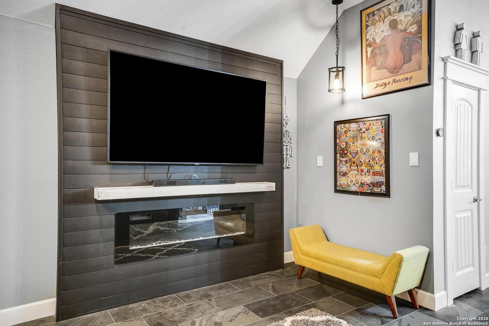 3754 Tumeric Cove Bulverde, TX 78163 - Photo 28 of 42 a living room with a fireplace and a flat screen tv