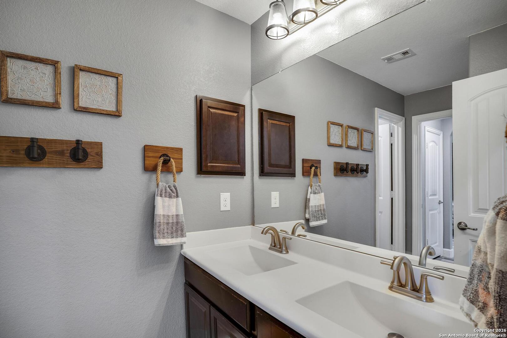 3754 Tumeric Cove Bulverde, TX 78163 - Photo 33 of 42 a bathroom with a sink and a mirror