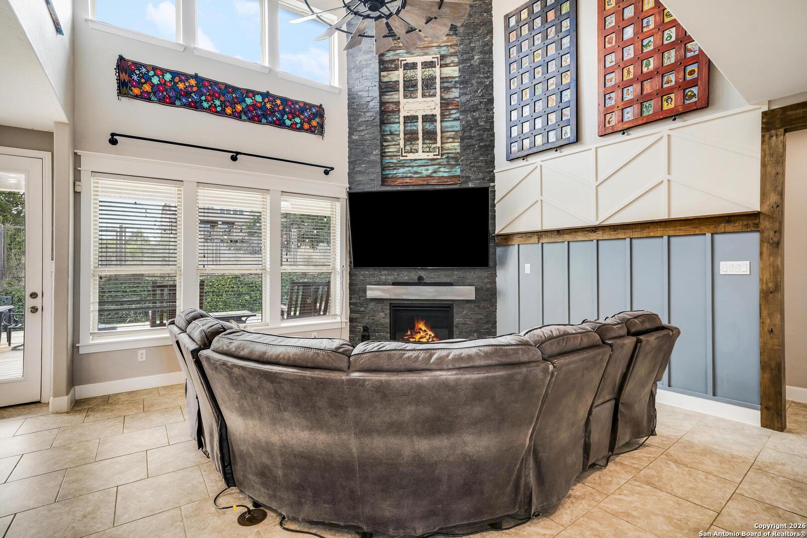 3754 Tumeric Cove Bulverde, TX 78163 - Photo 9 of 42 a living room with furniture a flat screen tv and a fireplace