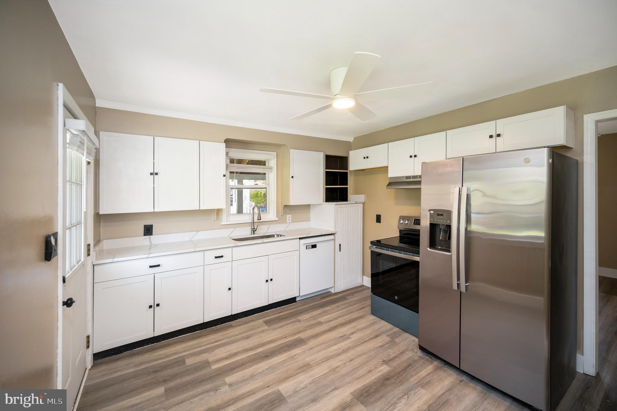 141 Onville Road Stafford, VA 22556 - Photo 12 of 44 a large kitchen with a refrigerator a sink dishwasher with a refrigerator and white cabinets