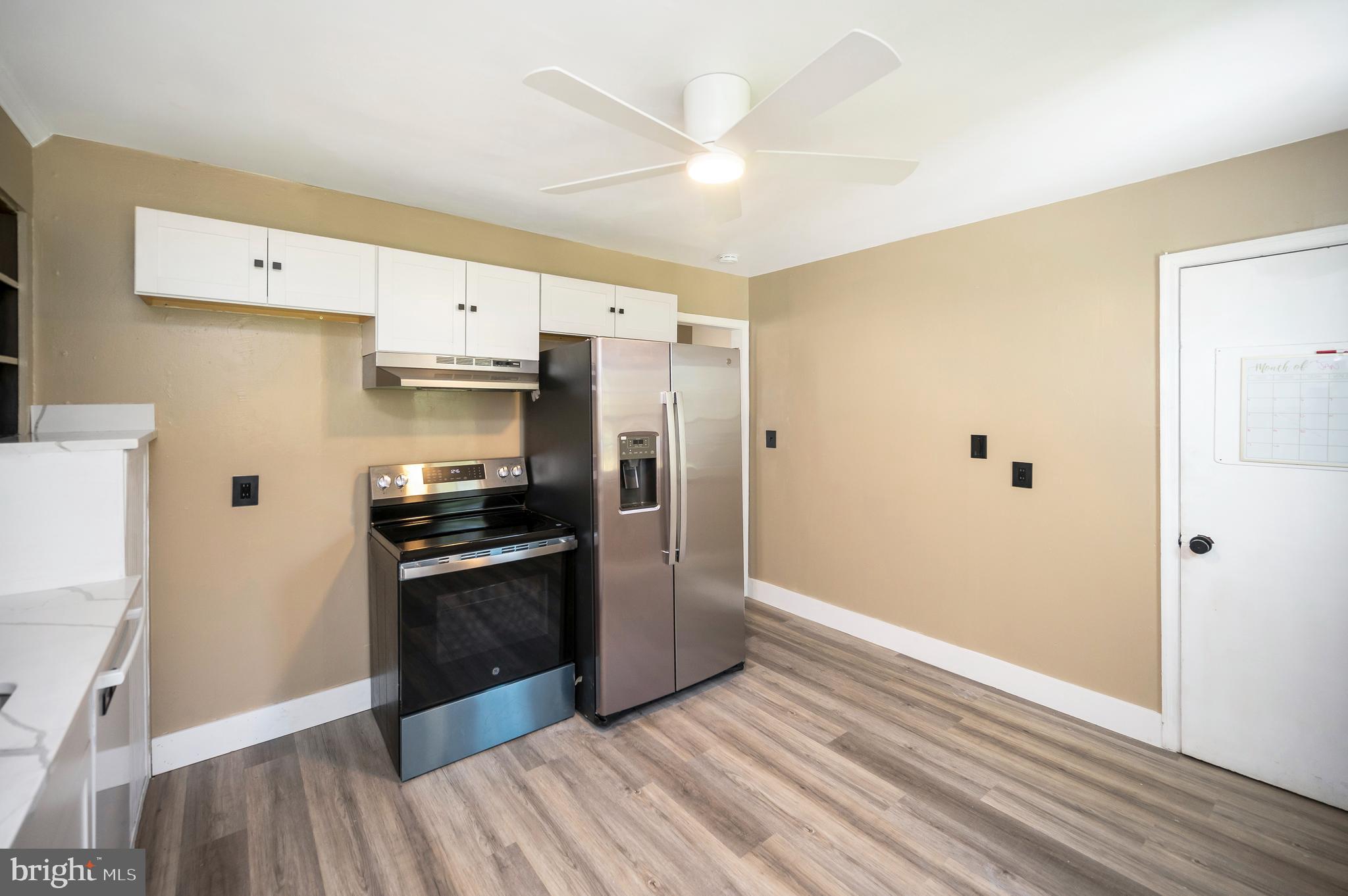 141 Onville Road Stafford, VA 22556 - Photo 15 of 44 a kitchen with stainless steel appliances a sink cabinets and wooden floor