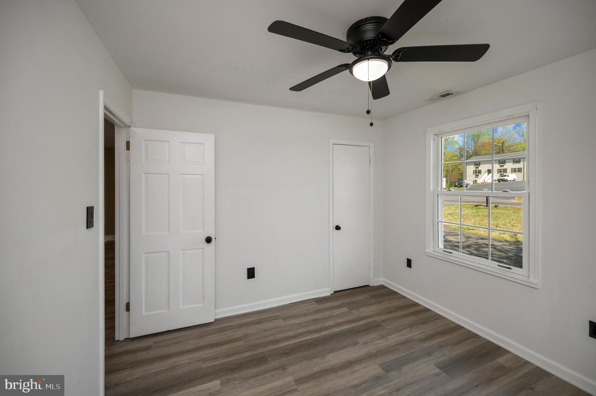 141 Onville Road Stafford, VA 22556 - Photo 18 of 44 a view of an empty room with a window and wooden floor