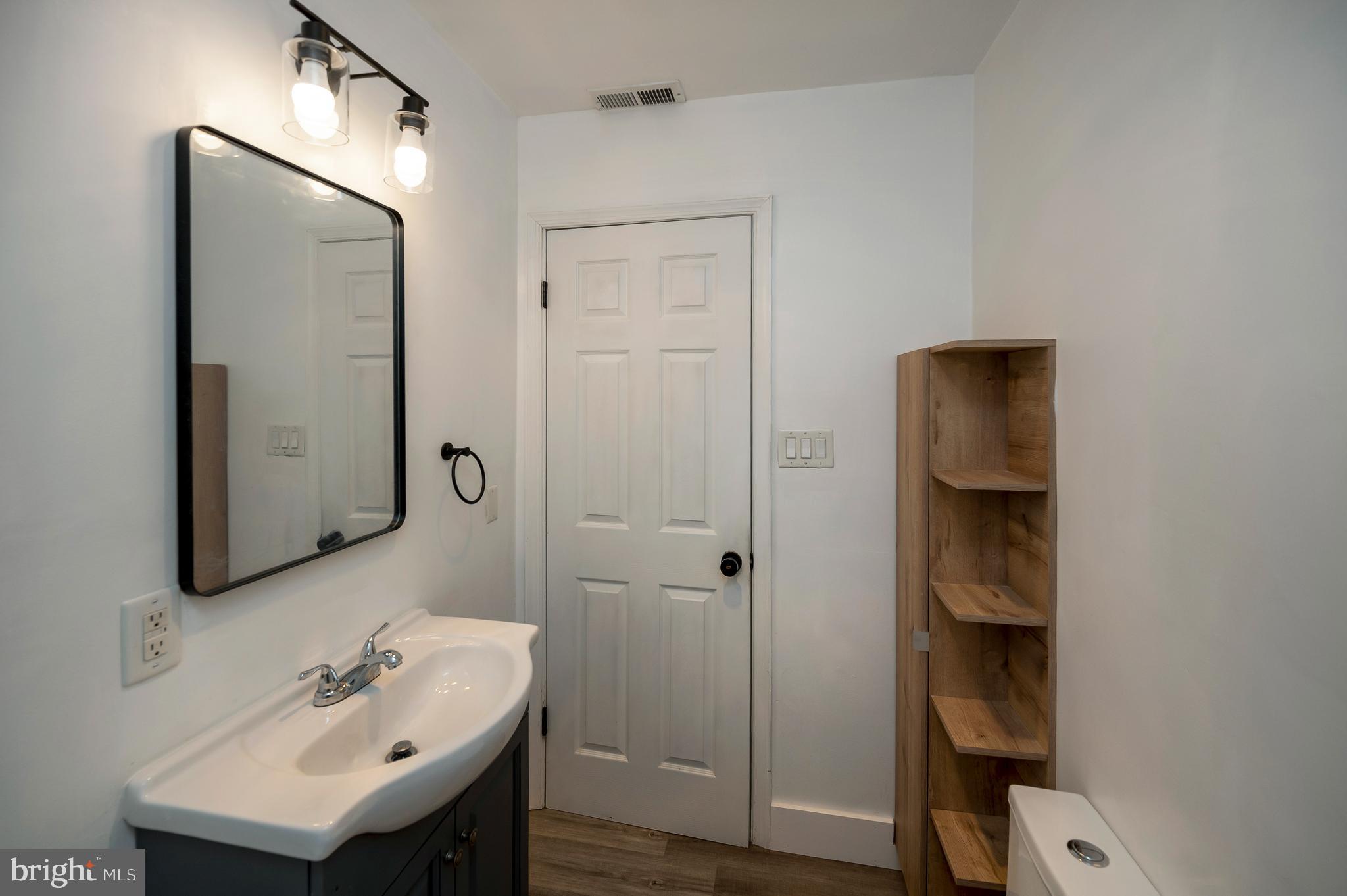 141 Onville Road Stafford, VA 22556 - Photo 3 of 44 a bathroom with a sink a mirror and shower