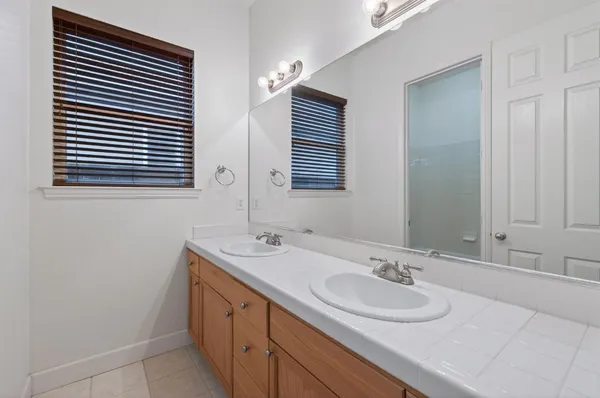 a bathroom with a sink double vanity and a mirror