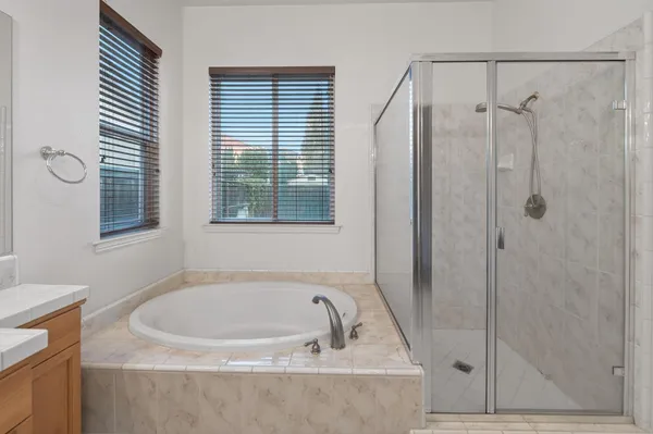 a bathroom with a granite countertop sink and shower