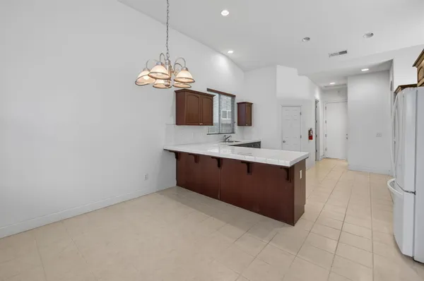 a kitchen with a chandelier and a sink