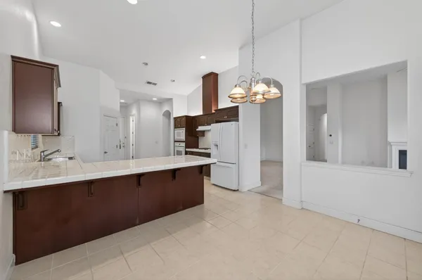 a spacious bathroom with a sink double vanity granite and a mirror