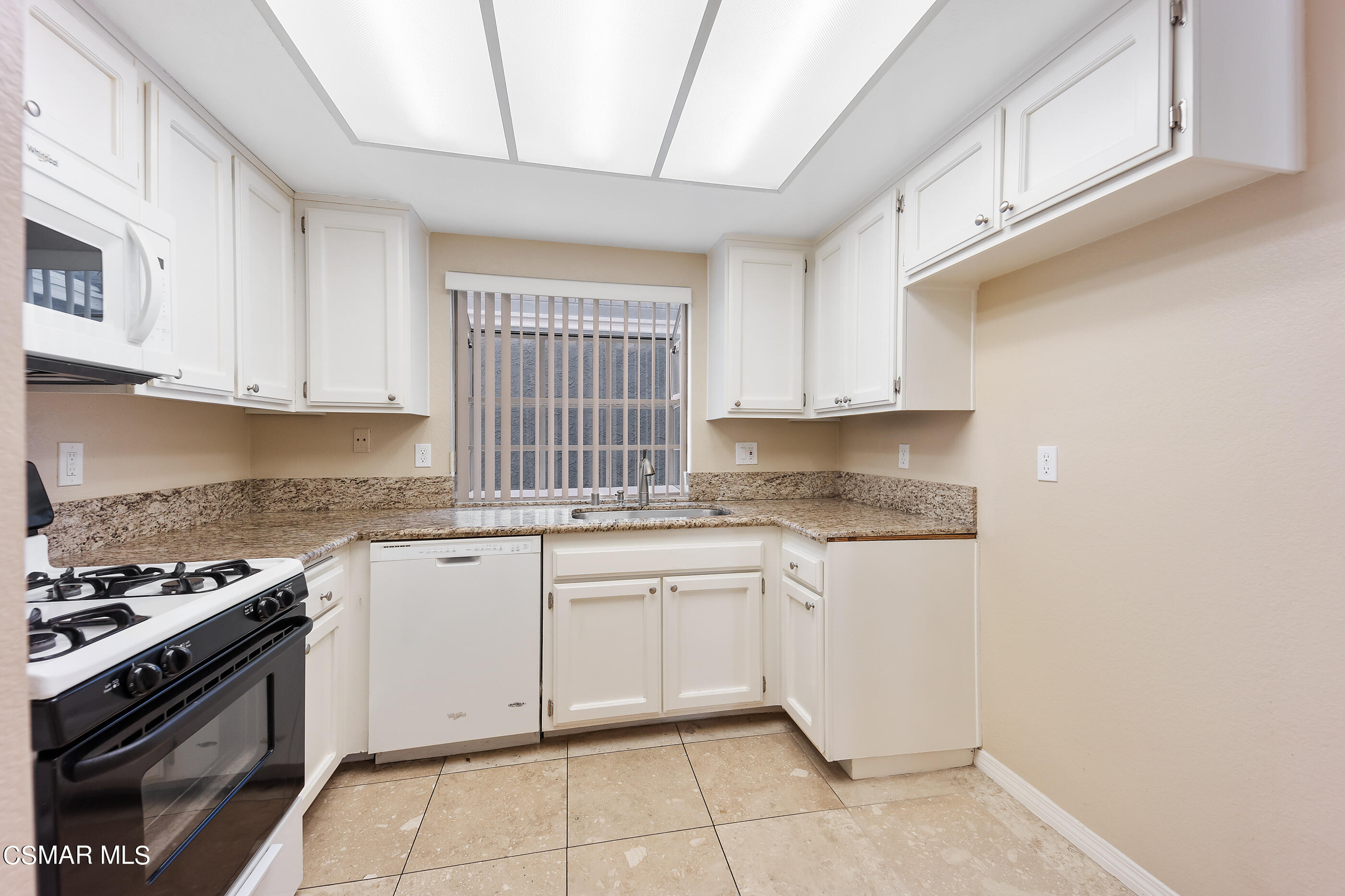 1866 Rory Lane, Unit 1 Simi Valley, CA 93063 - Photo 11 of 25 a kitchen with granite countertop white cabinets and appliances