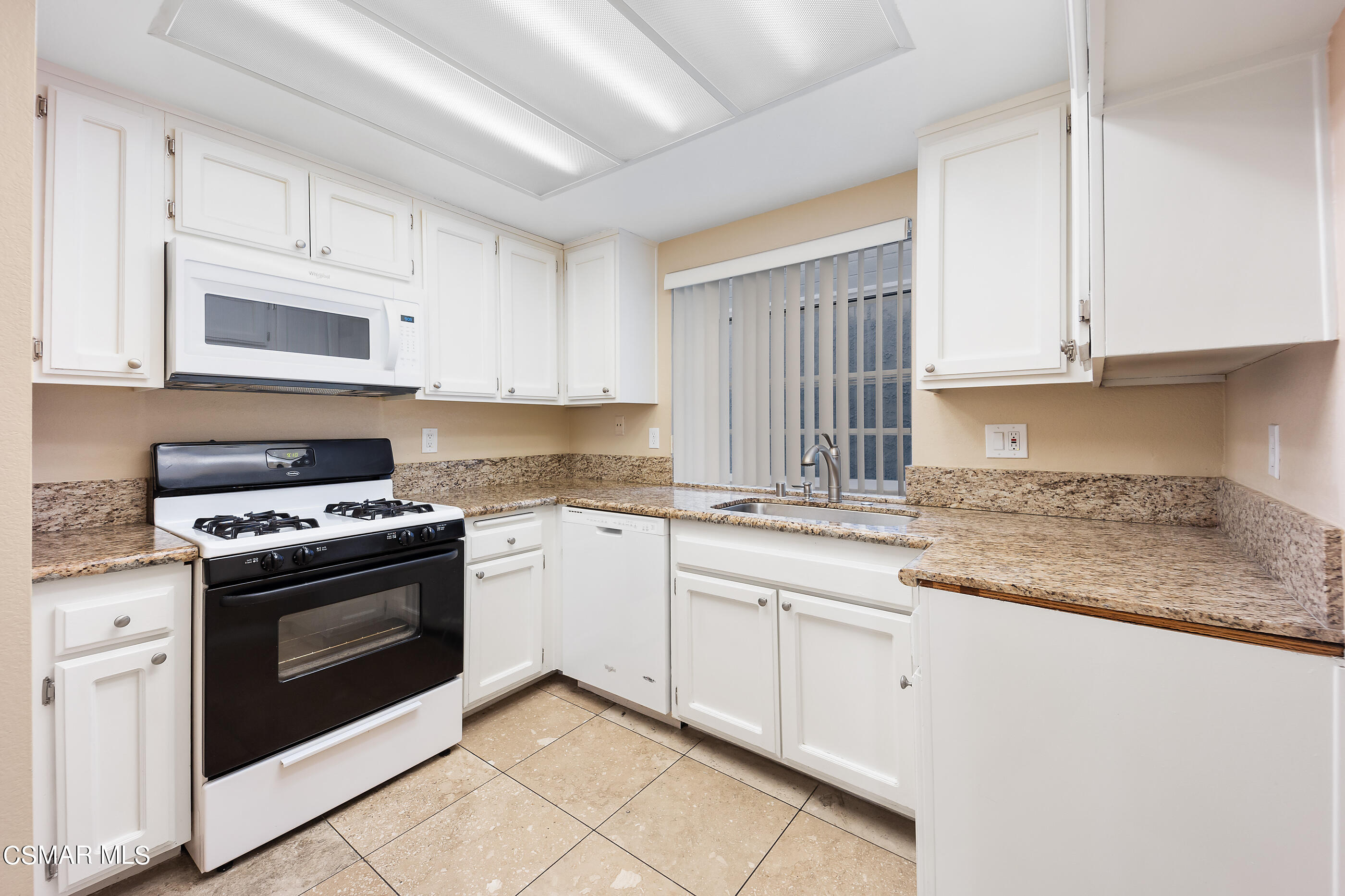 1866 Rory Lane, Unit 1 Simi Valley, CA 93063 - Photo 8 of 25 a kitchen with granite countertop white cabinets and stainless steel appliances