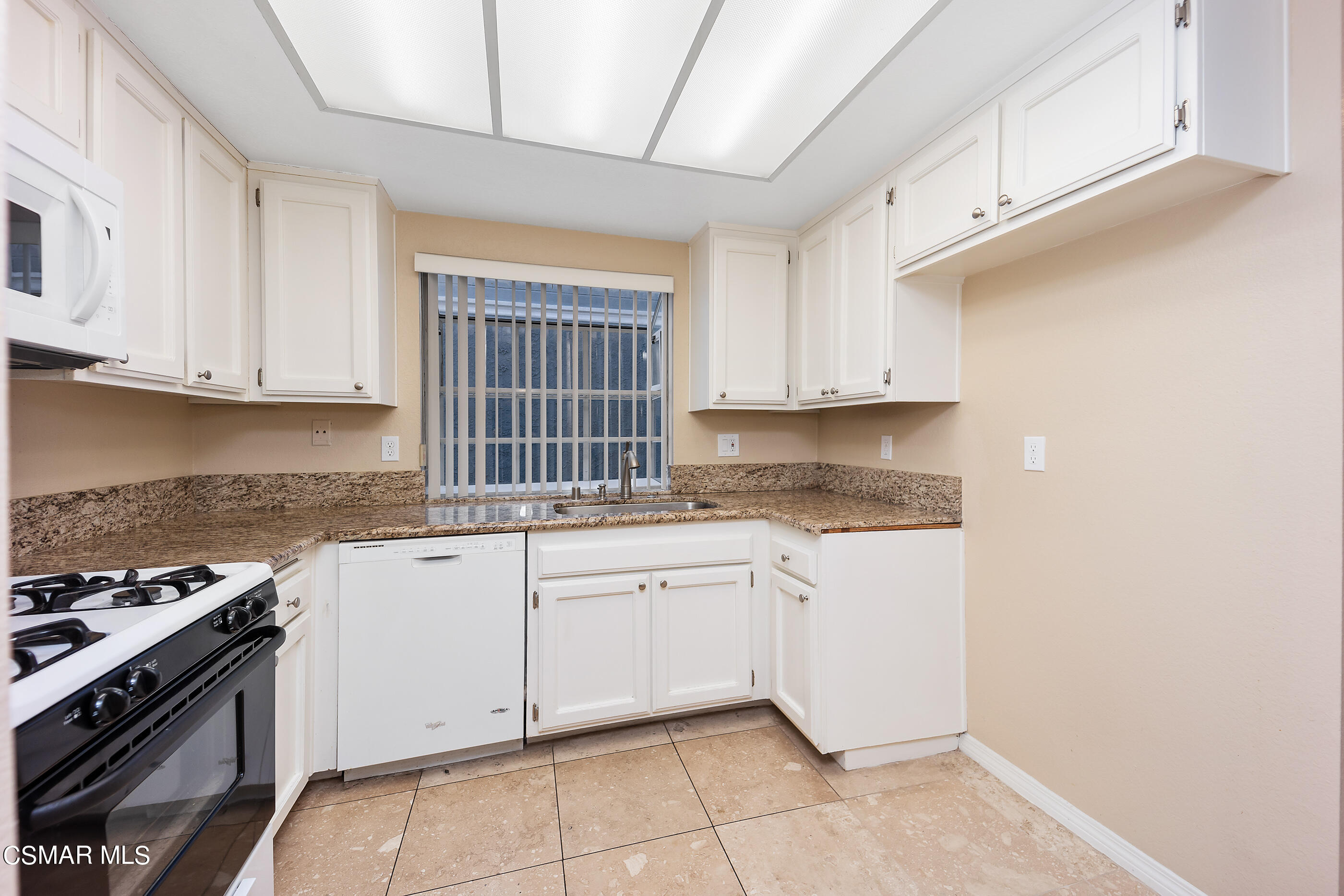 1866 Rory Lane, Unit 1 Simi Valley, CA 93063 - Photo 9 of 25 a kitchen with granite countertop white cabinets and appliances