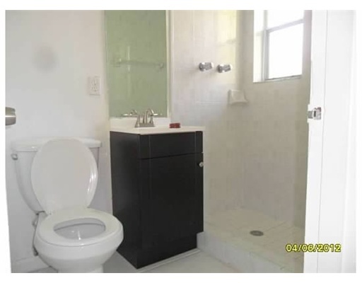 6330 Southwest 79th Street, Unit 23 South Miami, FL 33143 - Photo 7 of 7 a bathroom with a toilet a sink and mirror