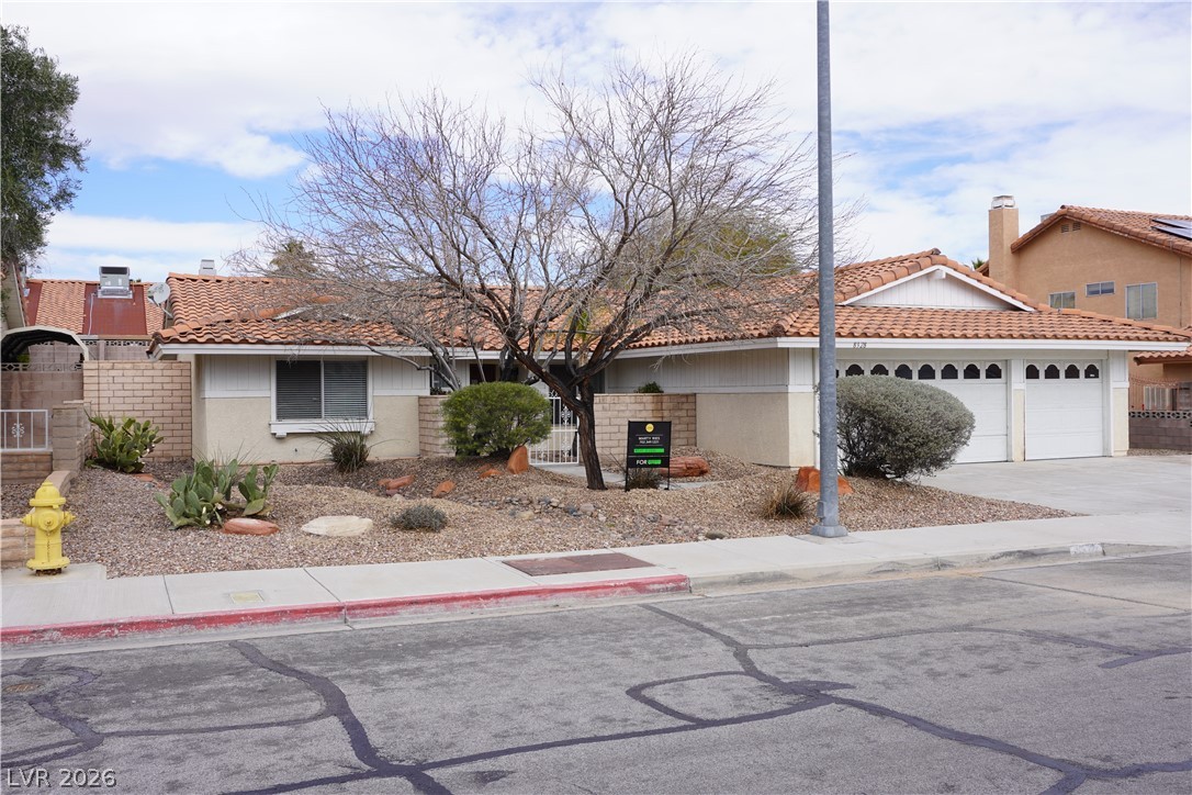 8328 Del Rey Avenue Las Vegas, NV 89117 - Photo 1 of 38 A terracotta-tiled roof crowns this residence, featuring an attached two-car garage and a neatly landscaped front yard.