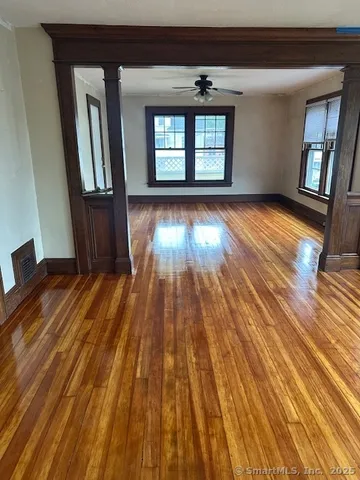 wooden floor in an empty room with windows