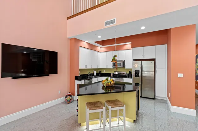 a kitchen with stainless steel appliances granite countertop a stove a microwave and cabinets